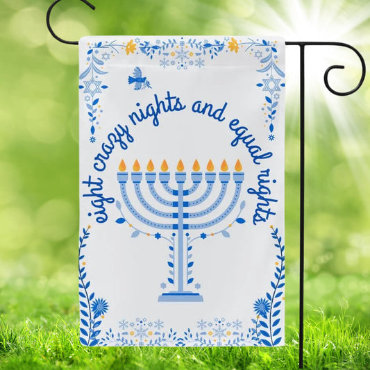 White garden flag with blue floral Hanukkah patterns on edges and a menorah in the center. In script font is reads eight crazy nights and equal rights