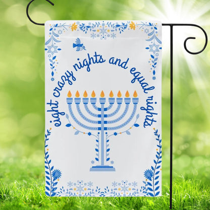 White garden flag with blue floral Hanukkah patterns on edges and a menorah in the center. In script font is reads eight crazy nights and equal rights