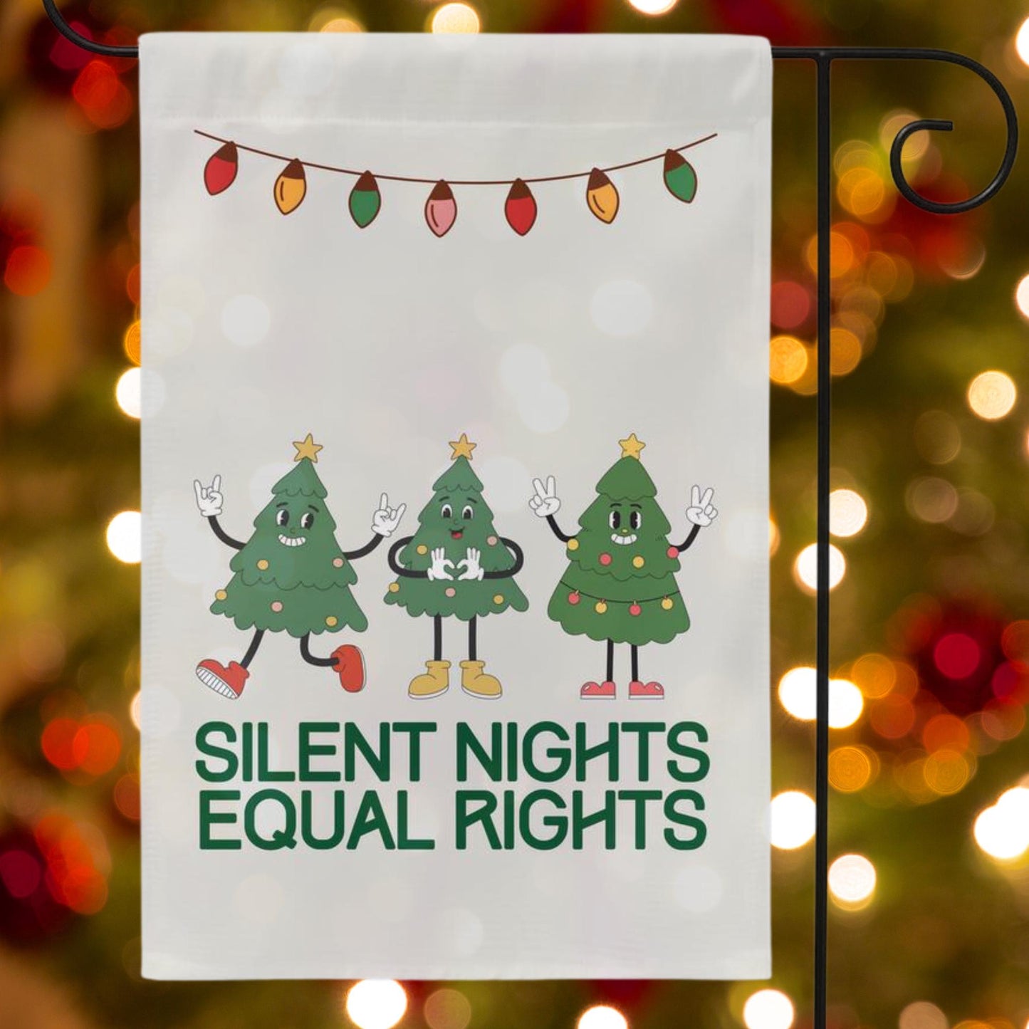off white christmas garden flag that reads silent nights equal rights at bottom. Above are three retro christmas trees.
